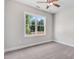 A cozy bedroom with a ceiling fan and a large window overlooking a beautiful wooded landscape at 222 Cherrybirch Ln, Zebulon, NC 27597