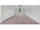 A large bonus room with plush carpeting and a high ceiling, featuring a window with scenic views at 222 Cherrybirch Ln, Zebulon, NC 27597