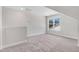 A well lit bonus room features carpet flooring and a large window overlooking neighborhood at 222 Cherrybirch Ln, Zebulon, NC 27597