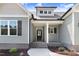 Inviting entryway showcasing a beautifully landscaped path leading to the front door with gray and white accents at 222 Cherrybirch Ln, Zebulon, NC 27597
