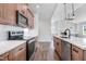 Bright kitchen featuring an island with a sink, stainless steel appliances, and wood cabinets with subway tile backsplash at 222 Cherrybirch Ln, Zebulon, NC 27597