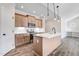 Modern kitchen featuring wood cabinets, stainless steel appliances, white countertops, and an island with pendant lighting at 222 Cherrybirch Ln, Zebulon, NC 27597