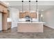 Modern kitchen featuring a center island, pendant lighting, and sleek appliances with hardwood style floors at 222 Cherrybirch Ln, Zebulon, NC 27597