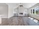 Bright living room featuring a vaulted ceiling, fireplace, built-in shelving, and large windows for natural light at 222 Cherrybirch Ln, Zebulon, NC 27597