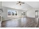 Expansive living room featuring hardwood floors, a cozy fireplace, and abundant natural light with white walls at 222 Cherrybirch Ln, Zebulon, NC 27597