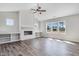 Spacious living room featuring built-in shelving, a fireplace, and large windows offering plenty of natural light at 222 Cherrybirch Ln, Zebulon, NC 27597