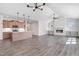 Open-concept living space showcasing hardwood floors, a cozy fireplace, and a modern kitchen with an island at 222 Cherrybirch Ln, Zebulon, NC 27597