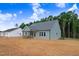 New construction home shows a covered back porch and ample space for outdoor entertaining with light gray siding at 222 Cherrybirch Ln, Zebulon, NC 27597