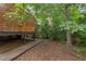 View of the backyard showing wooded and green foliage area and the deck of the house at 2222 Pathway Dr, Chapel Hill, NC 27516