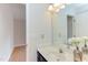 Well-lit bathroom with flowers on the vanity, a large mirror, and neutral walls at 2222 Pathway Dr, Chapel Hill, NC 27516