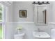 Bright bathroom featuring wainscoting, white fixtures and natural light at 2222 Pathway Dr, Chapel Hill, NC 27516