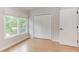This cozy bedroom features a bright window, closet, and light, wood-look flooring at 2222 Pathway Dr, Chapel Hill, NC 27516