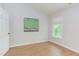 Bright, empty bedroom with hardwood floors and a window at 2222 Pathway Dr, Chapel Hill, NC 27516