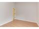 Empty bedroom with light, wood-look flooring, neutral walls, and a doorway at 2222 Pathway Dr, Chapel Hill, NC 27516
