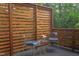 Outdoor deck area featuring a wooden privacy screen, a seating area, and surrounding greenery at 2222 Pathway Dr, Chapel Hill, NC 27516