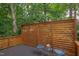 Outdoor deck with a privacy screen, seating, and a view of the surrounding greenery at 2222 Pathway Dr, Chapel Hill, NC 27516
