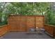 Outdoor deck area with a wooden privacy screen, seating, and a view of the surrounding greenery at 2222 Pathway Dr, Chapel Hill, NC 27516
