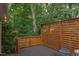View of a backyard wooden deck area with a wooden privacy fence and natural foliage all around at 2222 Pathway Dr, Chapel Hill, NC 27516