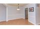 Bright dining area with wood floors and classic lighting fixture, adjacent to the kitchen with stainless appliances at 2222 Pathway Dr, Chapel Hill, NC 27516