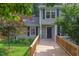 Charming home featuring a wooden walkway leading to the front door and dormer windows at 2222 Pathway Dr, Chapel Hill, NC 27516