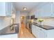 Kitchen with stainless steel appliances, granite counters, and white cabinetry with backyard views at 2222 Pathway Dr, Chapel Hill, NC 27516
