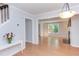 Open-concept living room with a fireplace and ample natural light, next to the stairs at 2222 Pathway Dr, Chapel Hill, NC 27516