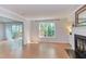 Inviting living room featuring wood floors, a fireplace with mantle and large windows offering natural light at 2222 Pathway Dr, Chapel Hill, NC 27516
