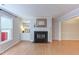 Spacious living room features wood floors, a fireplace with built-ins, and a large window at 2222 Pathway Dr, Chapel Hill, NC 27516