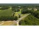 Birds eye view of a white single Gathering home with surrounding trees and a road nearby at 224 Grameta Ln, Lillington, NC 27546