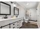 Renovated bathroom featuring a double vanity, modern fixtures, and a spacious walk-in shower at 224 Grameta Ln, Lillington, NC 27546