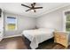 Cozy bedroom with ceiling fan, wood-look floors, natural light, and neutral paint at 224 Grameta Ln, Lillington, NC 27546