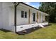 Close up of a covered front porch with wooden beams, sleek front door, and decorative shrubbery at 224 Grameta Ln, Lillington, NC 27546