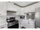 Updated kitchen with white cabinets, sleek stainless steel appliances, and stunning marble countertops at 224 Grameta Ln, Lillington, NC 27546