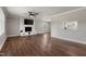 Bright living room features a brick fireplace, wood flooring, and modern ceiling fan at 224 Grameta Ln, Lillington, NC 27546