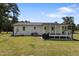 Backyard with a cozy covered porch and lush lawn at 224 Grameta Ln, Lillington, NC 27546