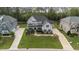 Aerial view of a large two-story home with manicured lawn, landscaping, and mature trees at 228 Cloverdale Rd, Apex, NC 27523