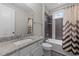 Bathroom featuring granite countertop, tiled bath and modern fixtures at 228 Cloverdale Rd, Apex, NC 27523