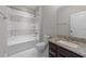 Bathroom featuring granite countertop, tiled bath, and modern fixtures at 228 Cloverdale Rd, Apex, NC 27523