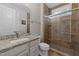 Bathroom featuring granite countertop, tiled shower, and modern fixtures at 228 Cloverdale Rd, Apex, NC 27523
