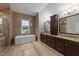 Luxurious bathroom boasts a soaking tub, tiled walls, and -and- vanity at 228 Cloverdale Rd, Apex, NC 27523