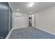 Bedroom featuring paneled accent wall, carpeted floors, and a double-door closet at 228 Cloverdale Rd, Apex, NC 27523