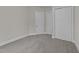 Bedroom featuring neutral colors, carpeted floors, and double-door closet storage at 228 Cloverdale Rd, Apex, NC 27523