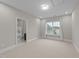 Bedroom featuring neutral carpet, a window and view into bathroom at 228 Cloverdale Rd, Apex, NC 27523