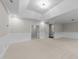 Spacious bonus room with neutral carpet, wainscoting and tray ceiling at 228 Cloverdale Rd, Apex, NC 27523