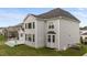Rear exterior view of a two-story home with multiple windows and a large deck at 228 Cloverdale Rd, Apex, NC 27523