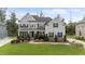 A charming two-story home with gray siding, black shutters, and a beautifully landscaped front yard at 228 Cloverdale Rd, Apex, NC 27523