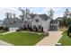 Expansive lawn and manicured landscaping surrounding this two-story home with gray siding at 228 Cloverdale Rd, Apex, NC 27523