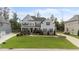 Beautiful two-story home with manicured lawn, elegant landscaping, and gray siding at 228 Cloverdale Rd, Apex, NC 27523