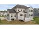 Rear exterior view of a two-story home, deck, and multiple windows for natural light at 228 Cloverdale Rd, Apex, NC 27523