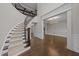 Elegant home foyer featuring a curved staircase, hardwood floors, and bright lighting at 228 Cloverdale Rd, Apex, NC 27523